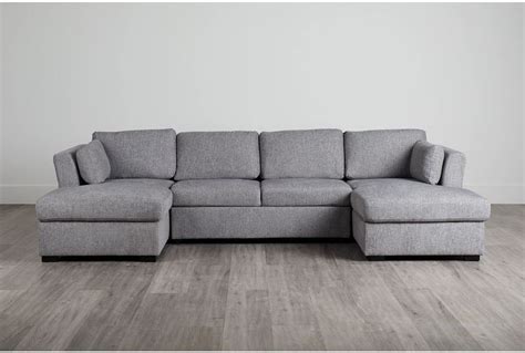 Slightly tapered legs, square arms, and a cushion back draw inspiration from traditional design. . Amber dark gray fabric double chaise sleeper sectional
